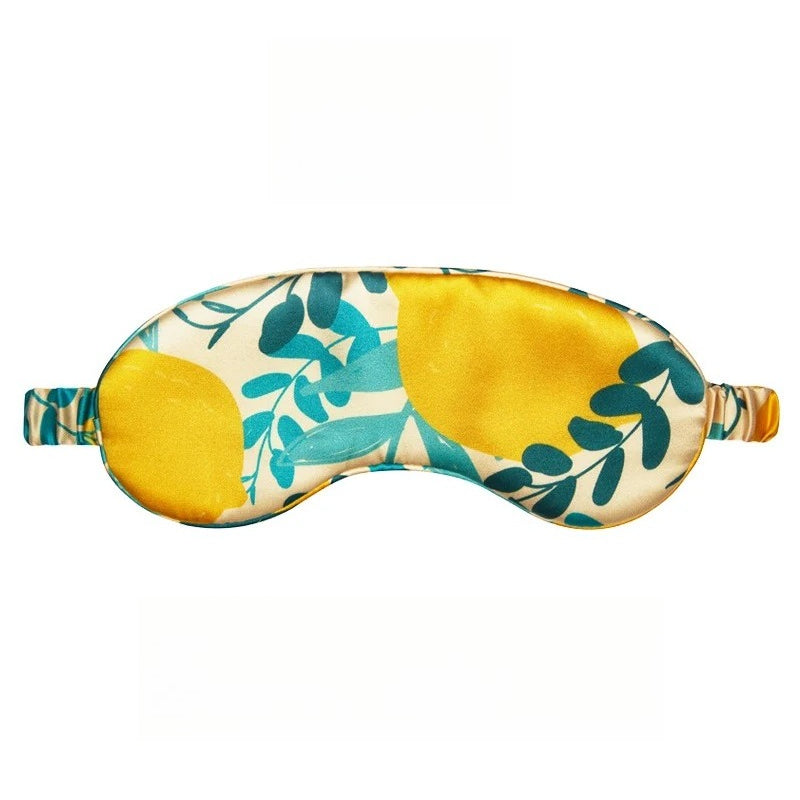 SUUMEE printed 100% mulberry silk sleep eye mask rests on a soft beige surface, highlighting its light-blocking, breathable d