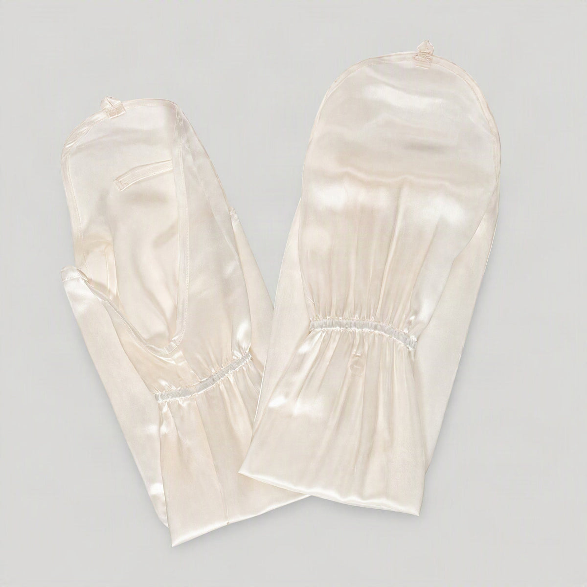 Pair of ivory mulberry silk UV arm sleeves with hand covers, laid flat