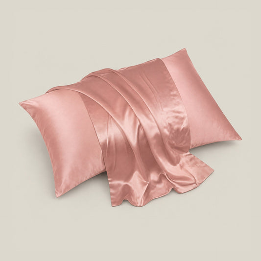 Rectangular silk pillowcase with blue, orange, and gray floral and butterfly pattern on a cream background, displayed flat