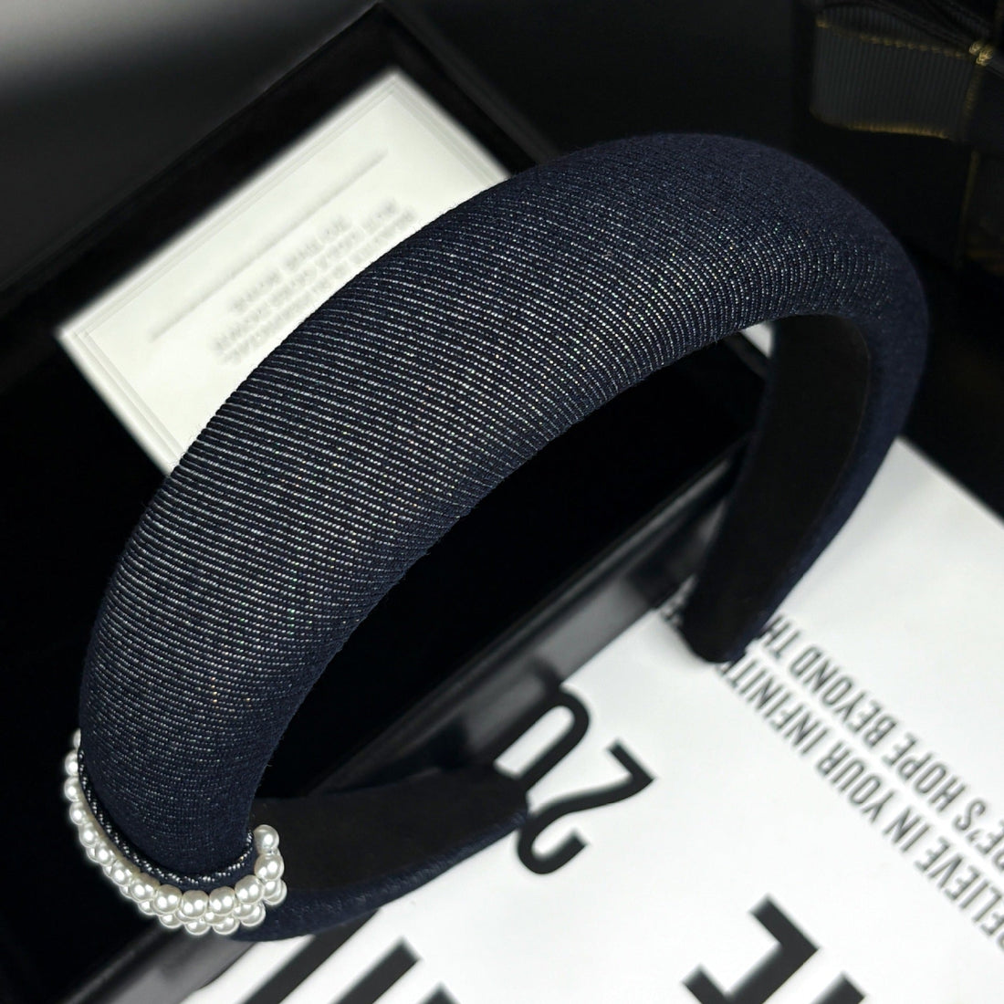 Navy blue textured fabric headband with pearl-embellished clasp