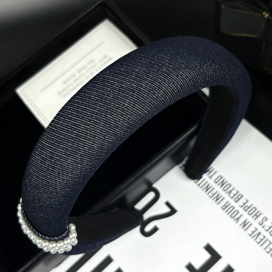Navy blue textured fabric headband with pearl-embellished clasp