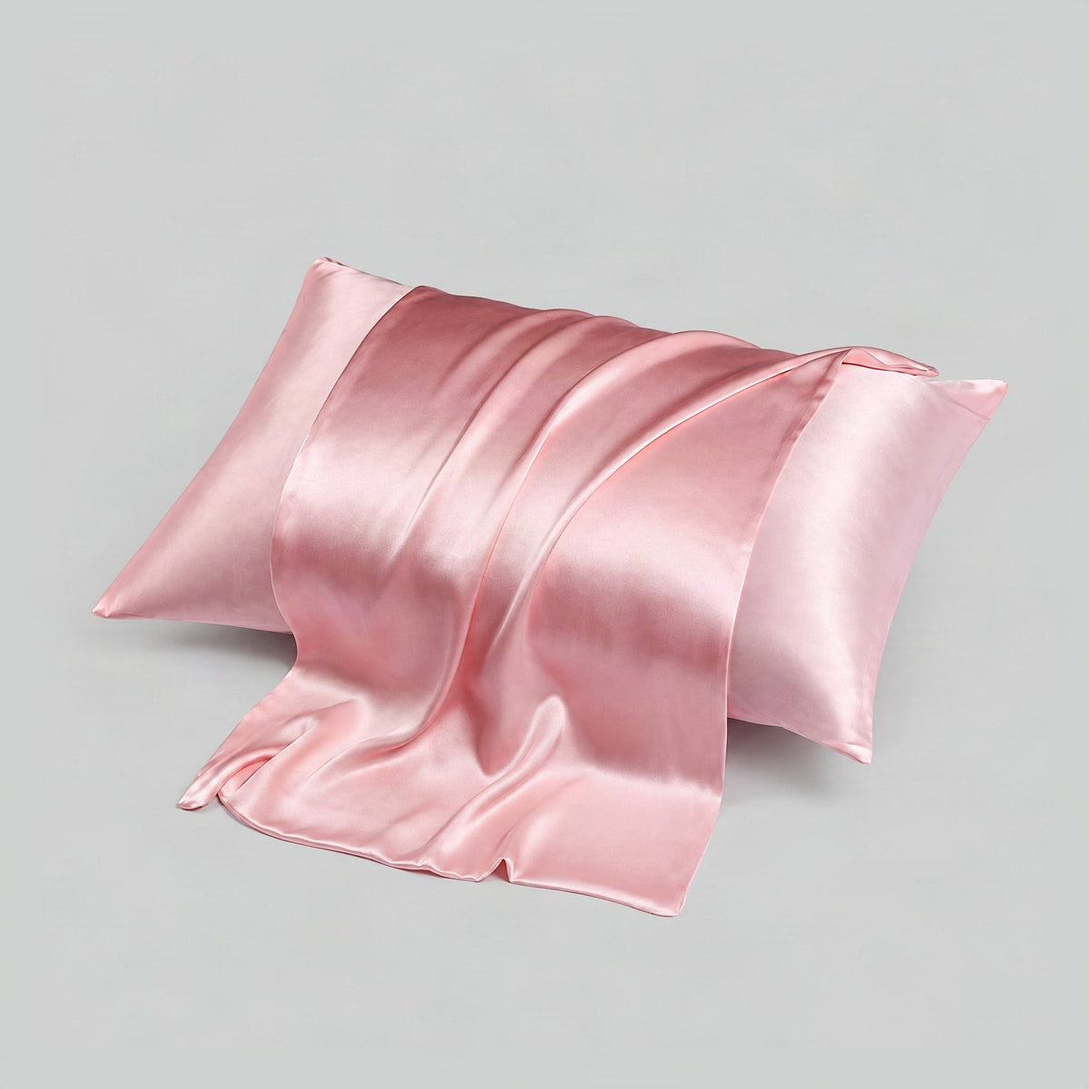 Resting on a SuuSilk 16 Momme silk envelope pillowcase, soft mulberry double-sided fabric in warm bedroom light.
