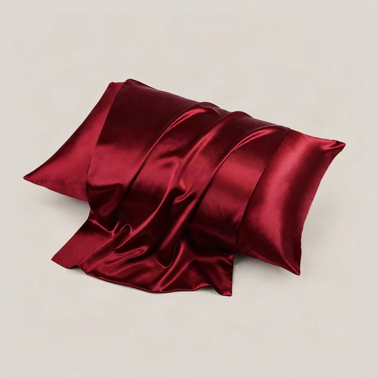 SuuSilk 22 Momme glossy multicolour mulberry silk pillowcase styled on a bed, showing satin sheen and hidden zipper detail