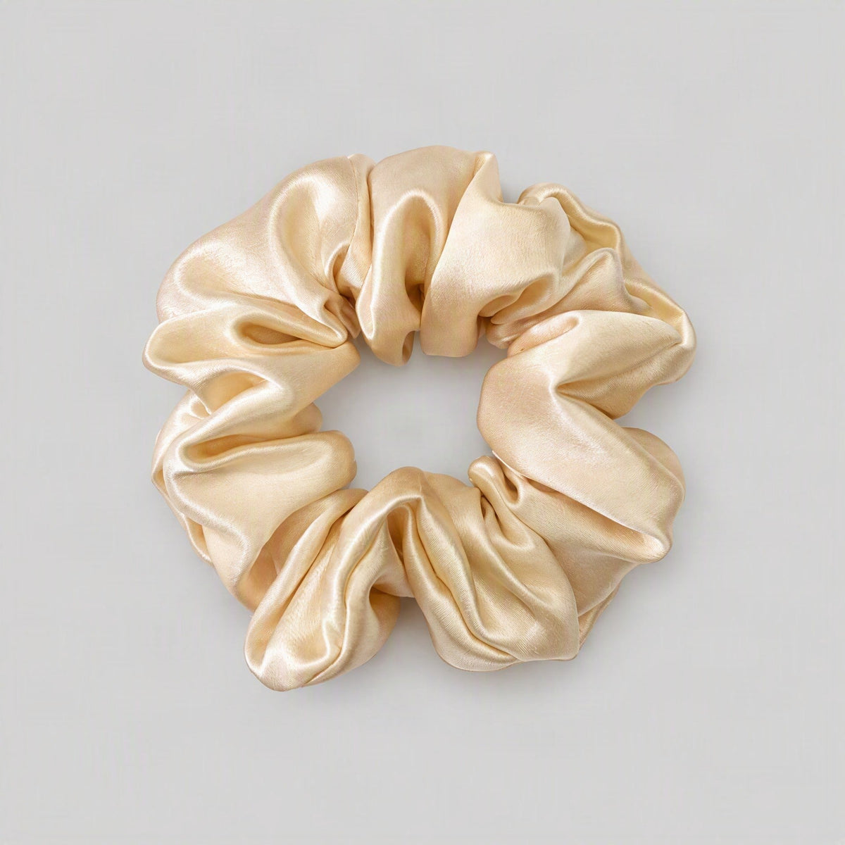 SuuSilk mulberry silk scrunchie resting on a soft surface, showcasing its gentle texture for everyday ha