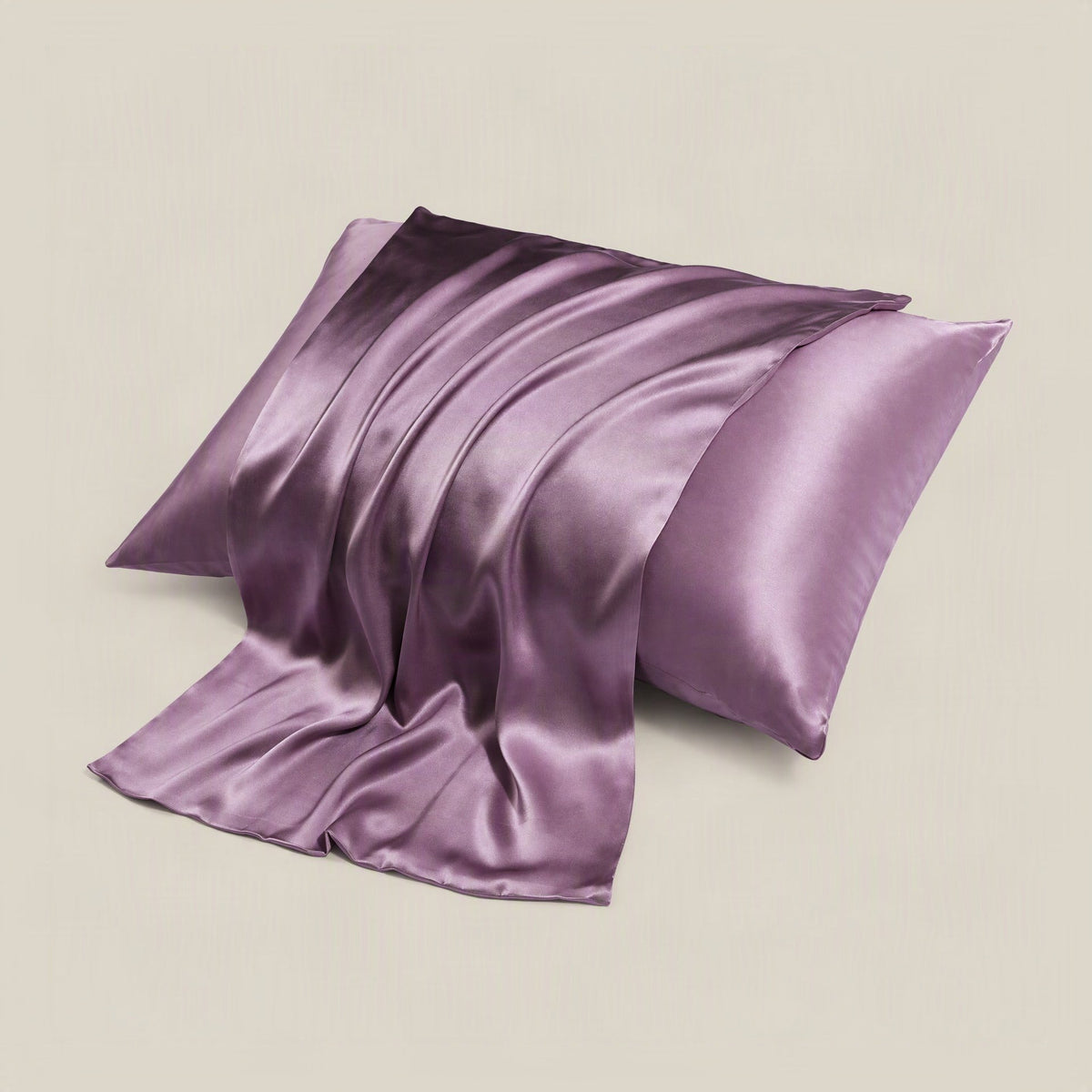 SuuSilk 16 Momme mulberry silk pillowcase in soft ivory, neatly placed on a styled bed with neutral linen bedding and natural