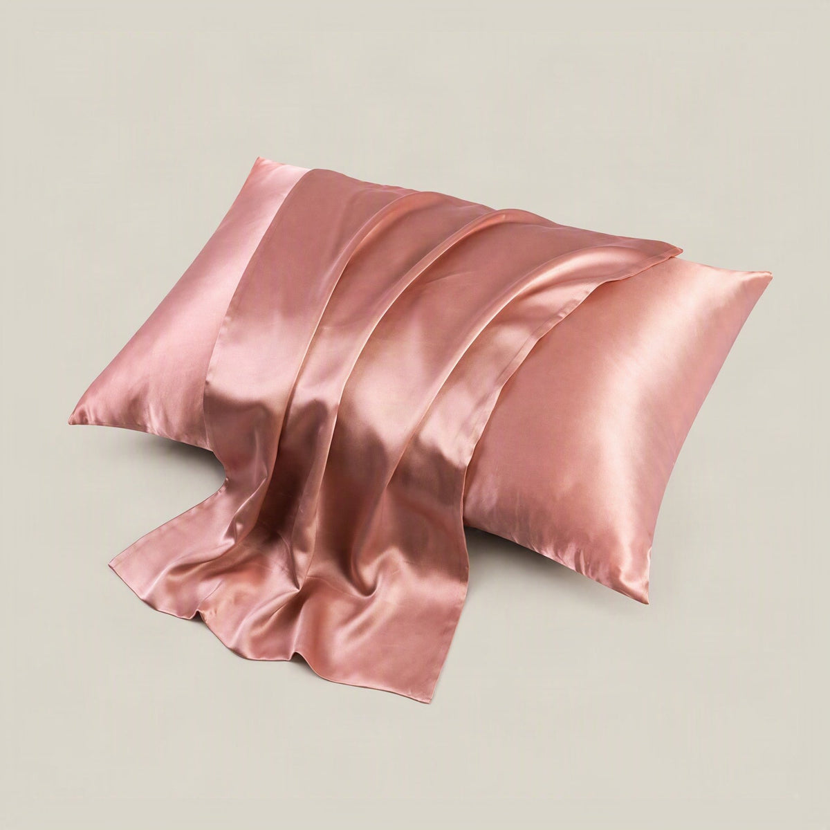 SuuSilk 19 Momme mulberry silk pillowcase in soft blush pink, neatly styled on a bed with hidden zipper detail visible