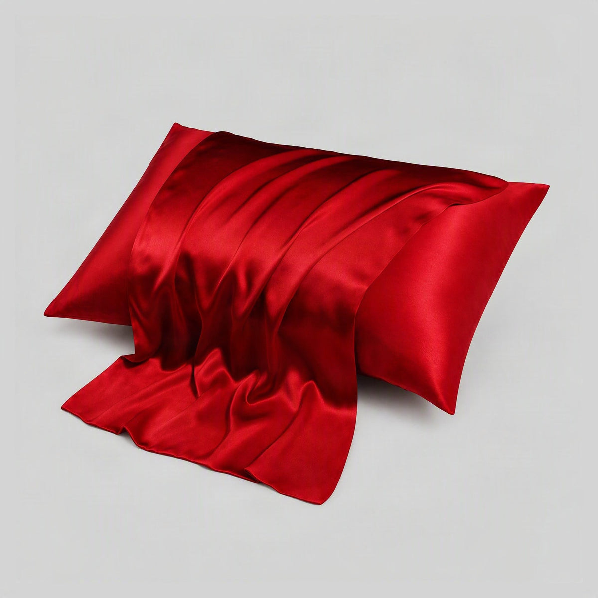 Mulberry silk pillowcase detail showing hidden envelope closure on soft white bedding in a bright, airy bedroom setting.