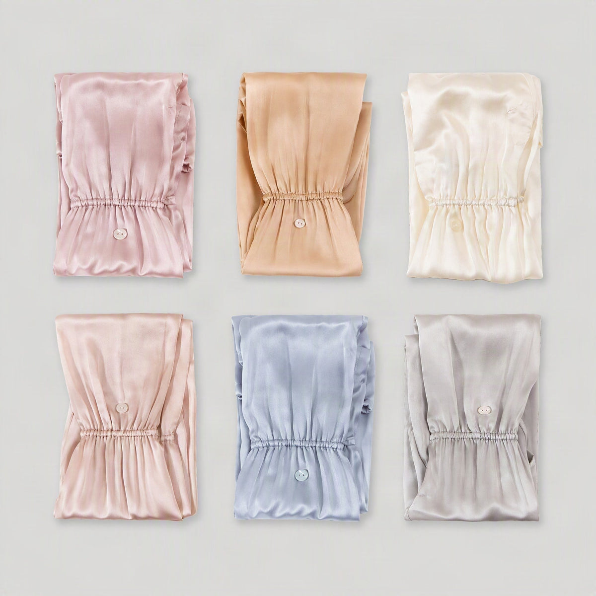 Six colourways of the mulberry silk UV arm sleeves folded and laid out in a grid
