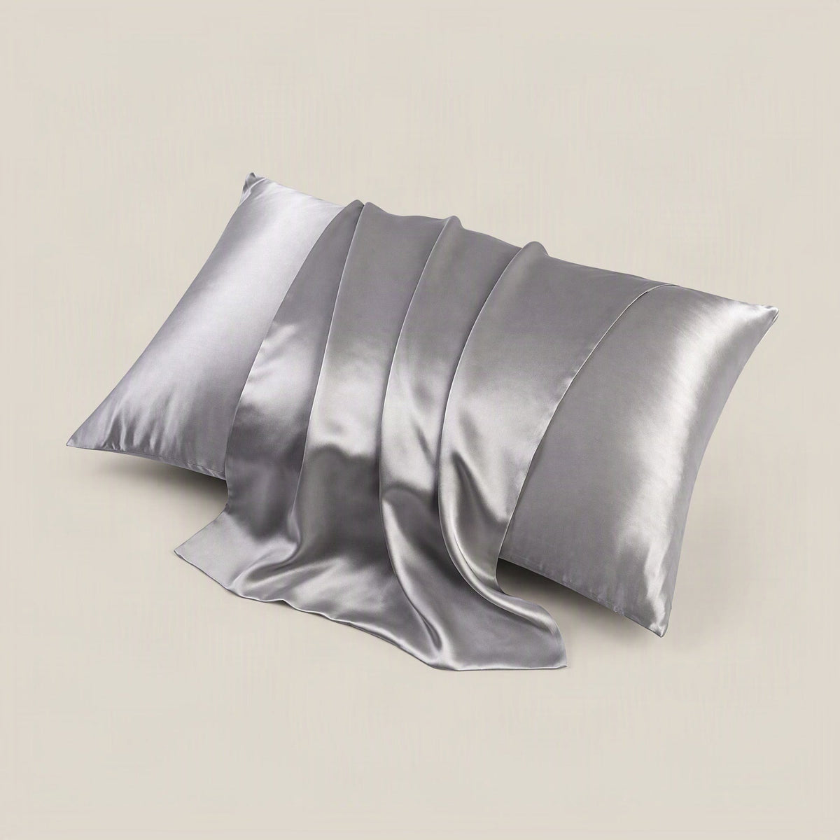 SuuSilk 19 Momme silk pillowcase draped on a styled bed, showing smooth mulberry silk fabric and discreet hidden zipper