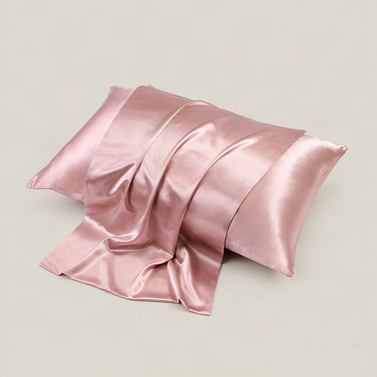 SuuSilk 22 Momme glossy mulberry silk pillowcase with hidden zipper styled on a neutral linen bed setting