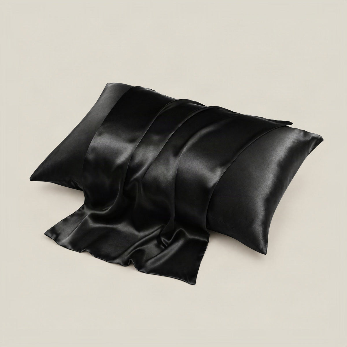SuuSilk 16 Momme mulberry silk envelope pillowcase in soft cream color, displayed folded on a neutral beige surface.