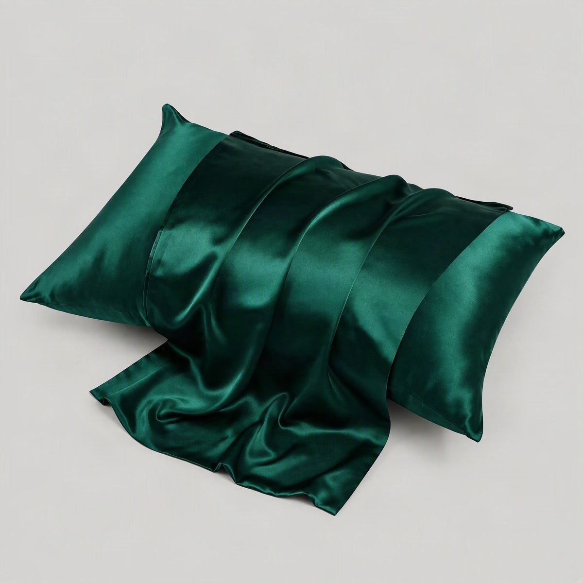 SuuSilk 22 Momme matte silk envelope pillowcase in ivory, softly draped across a sunlit bed.