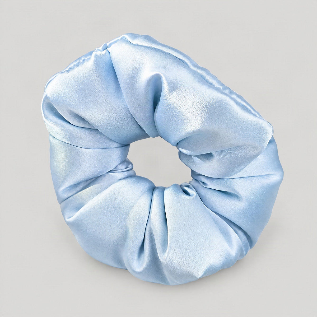 SuuSilk 30 Momme mulberry silk scrunchie in soft blush, padded and gentle on hair, styled on a vanity for everyday wear