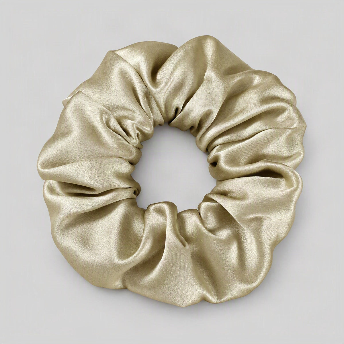 Black 30 momme mulberry silk scrunchie resting on a smooth surface, showcasing its gentle, hair-friendly everyday wear design