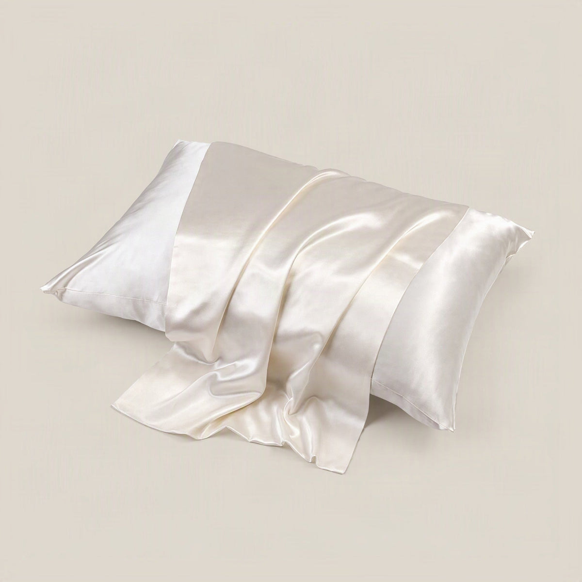 SuuSilk 22 Momme glossy mulberry silk envelope pillowcase with hidden closure, draped on a bed in soft natural light