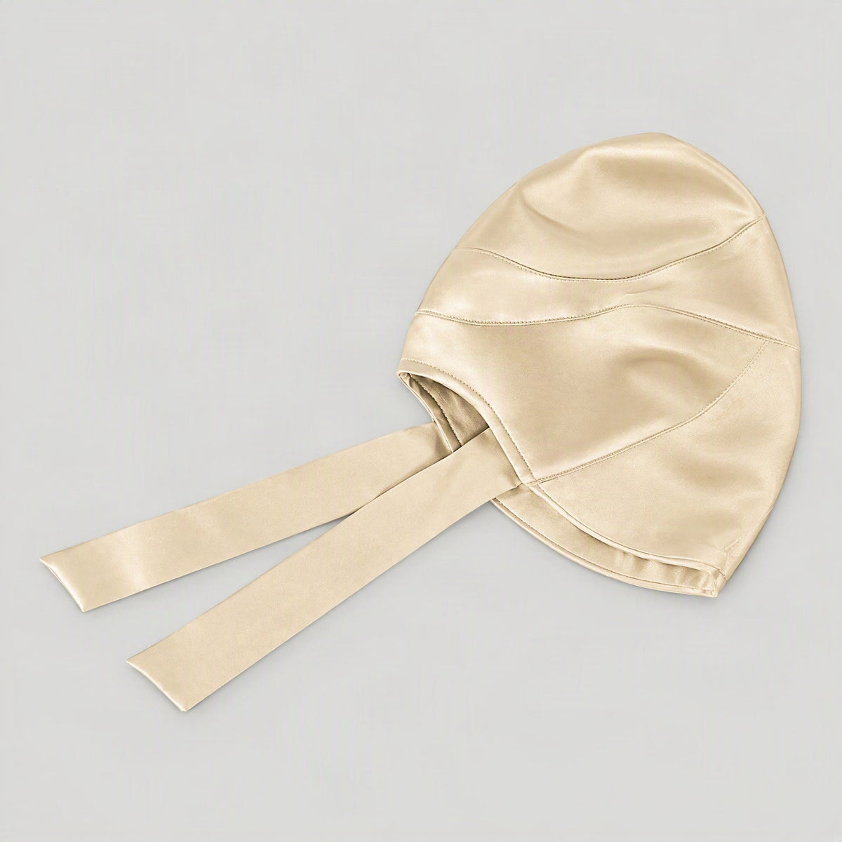 Champagne mulberry silk wide-brim sun hat laid flat, showing the long back ties