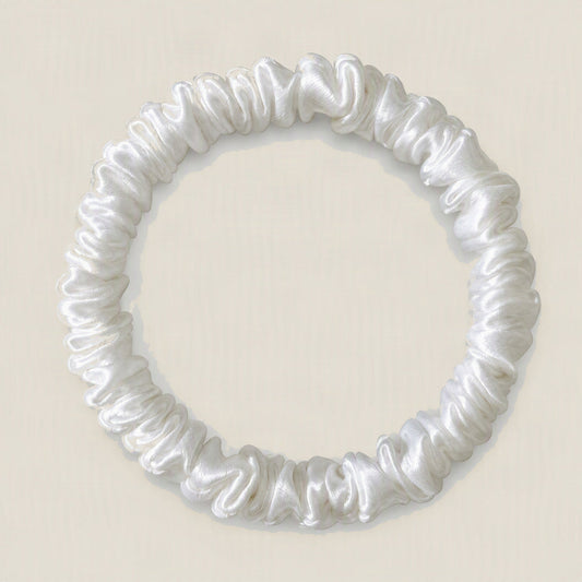 SuuSilk 19 Momme Slim 100% Mulberry Silk Scrunchie in soft cream color, displayed against a clean white background