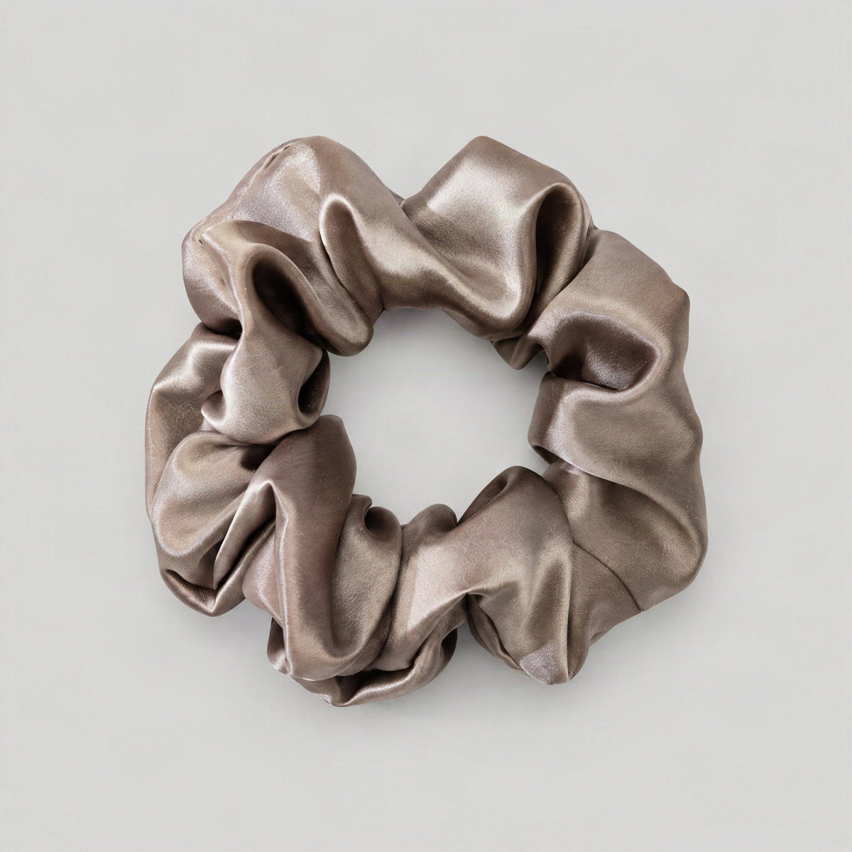SuuSilk Mulberry Silk Scrunchie in soft pastel hue, gently styled on a bedside table with morning light