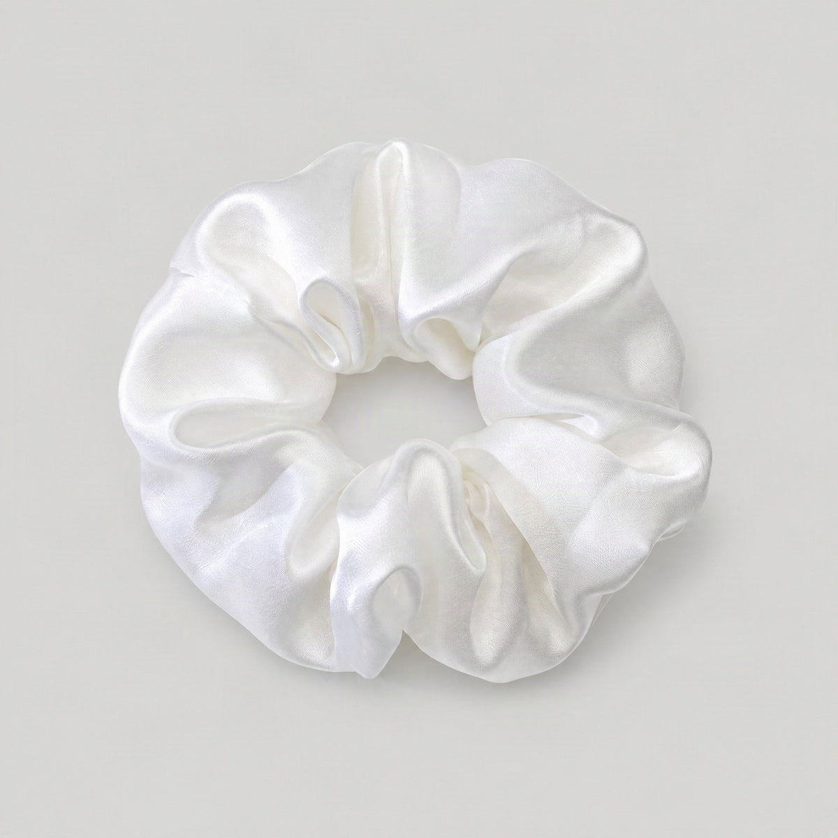 Soft lavender mulberry silk scrunchie styled in a low ponytail, showcasing its gentle, hair-friendly weave on natural