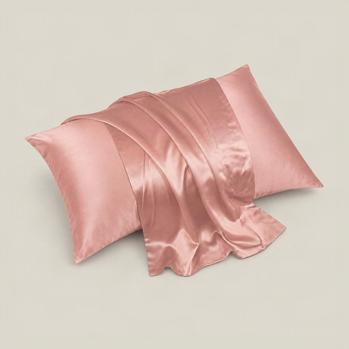 Soft ivory silk pillowcase with hidden zipper elegantly arranged on a white bed, showcasing smooth mulberry silk finish.