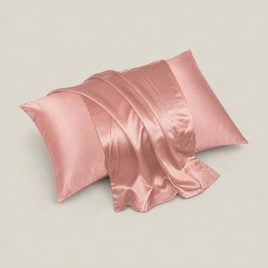 Soft ivory silk pillowcase with hidden zipper elegantly arranged on a white bed, showcasing smooth mulberry silk finish.