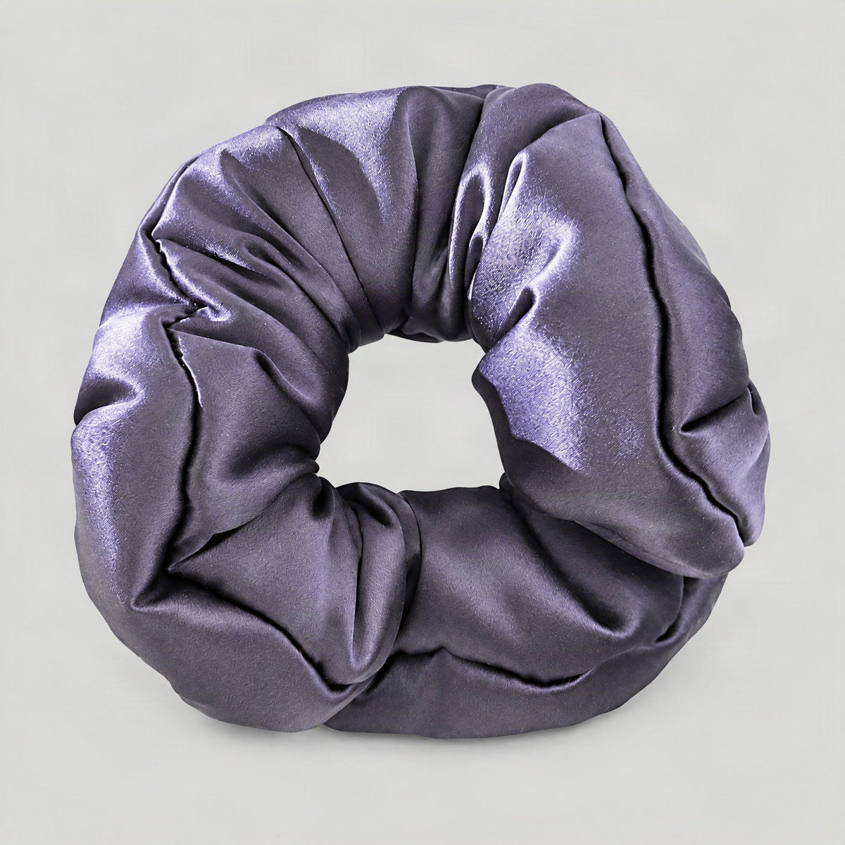 SuuSilk 30 Momme padded mulberry silk scrunchie in soft blush pink, styled on a marble surface for everyday hair care.