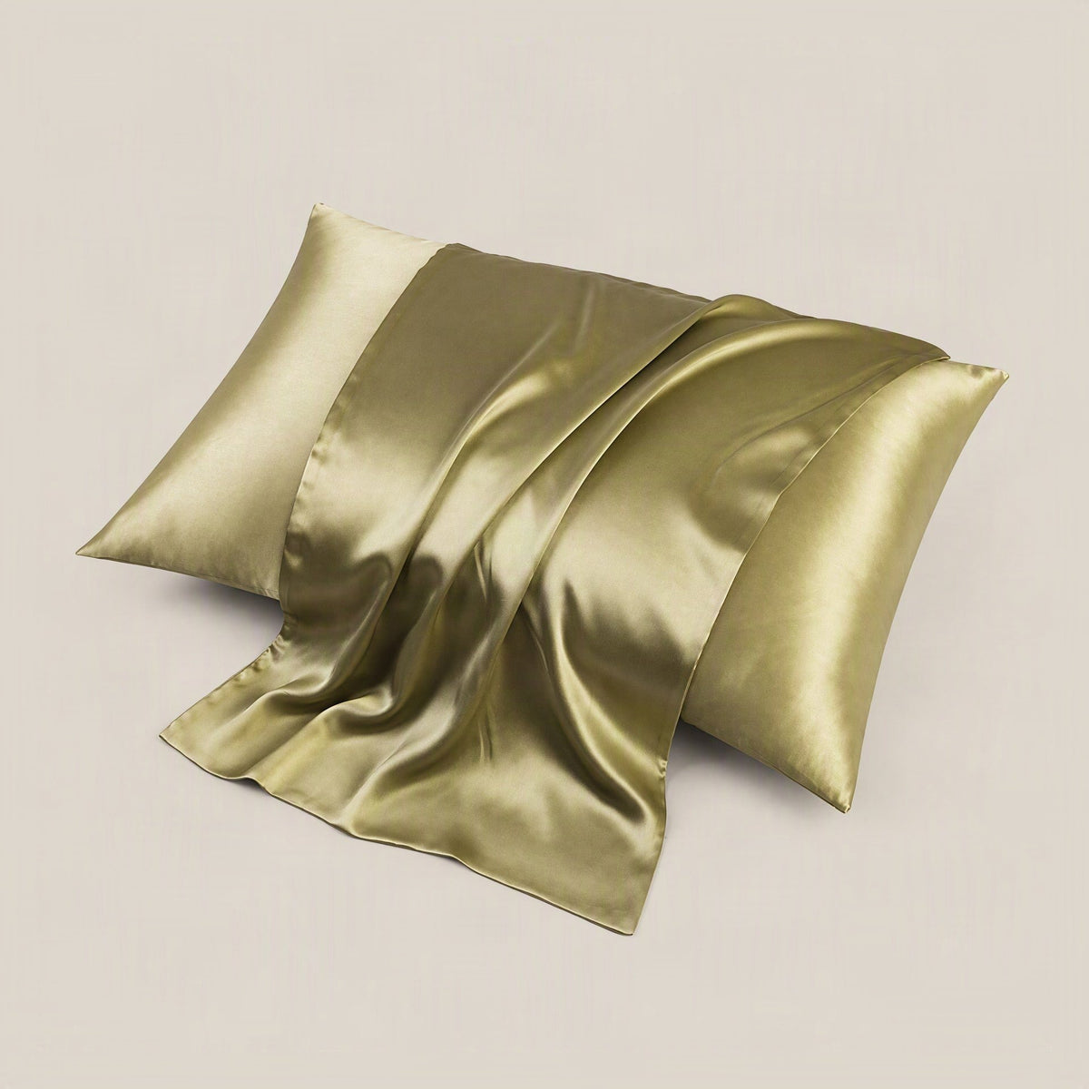 SuuSilk 19 Momme silk pillowcase in soft blush pink, displayed on a styled bed with neutral linen bedding