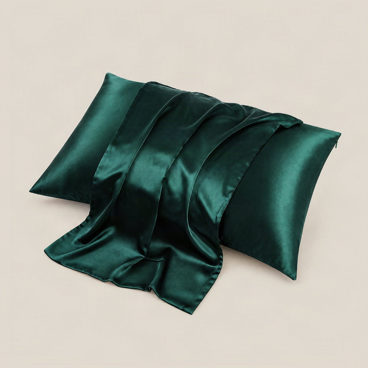 SuuSilk 19 Momme mulberry silk pillowcase in soft blush pink, shown draped on a bed with hidden zipper detail visible