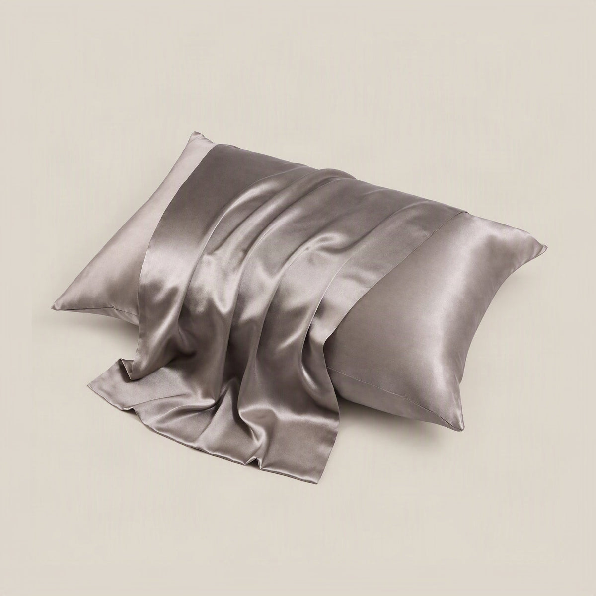 SuuSilk 22 Momme matte mulberry silk pillowcase in soft neutral tone, displayed on a styled bed with hidden zipper detail vis