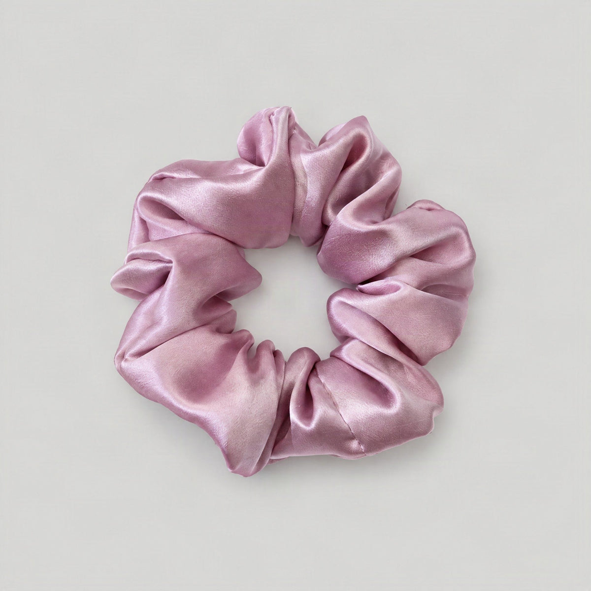 SuuSilk Mulberry silk scrunchie in soft neutral tone, gently styled on a vanity for everyday hair care
