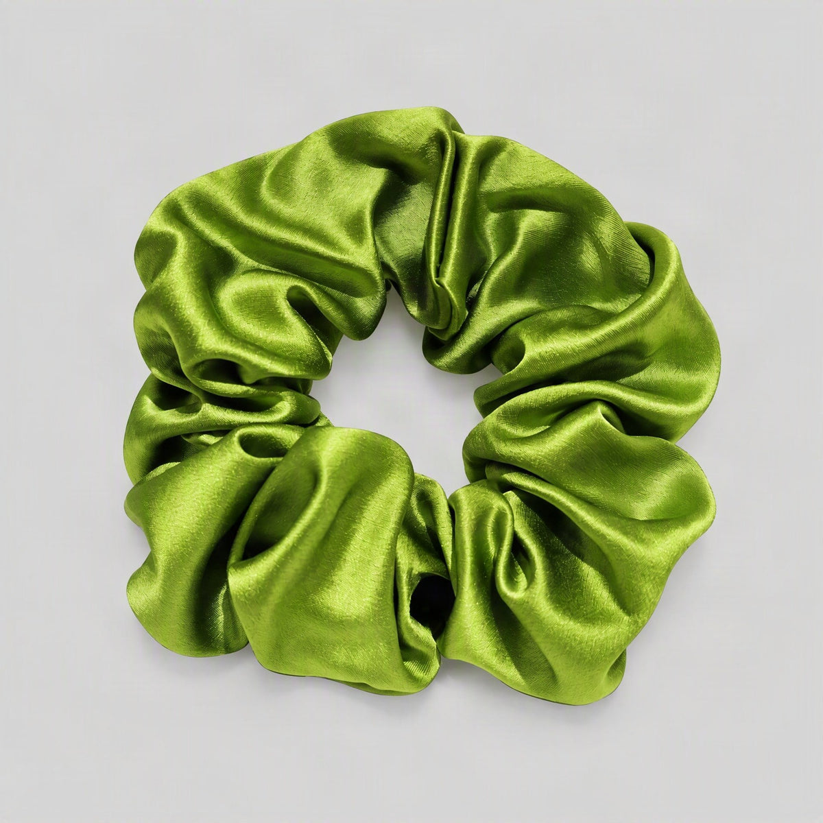 SuuSilk 30 Momme mulberry silk scrunchie in soft blush pink, gently scrunched on a marble surface