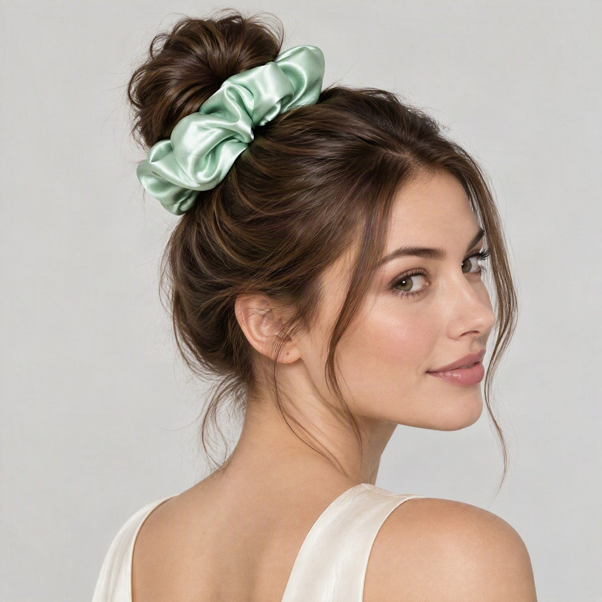Lustrous unpadded 30 momme mulberry silk scrunchie in rich burgundy resting on a marble countertop