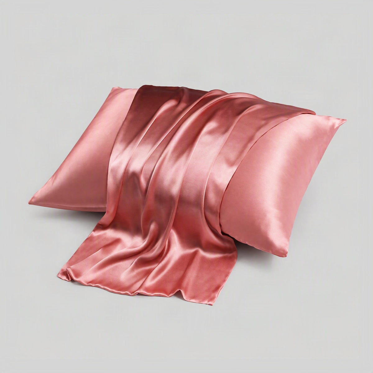 SuuSilk 16 Momme mulberry silk envelope pillowcase in soft pink, hidden closure detail visible on a styled bed