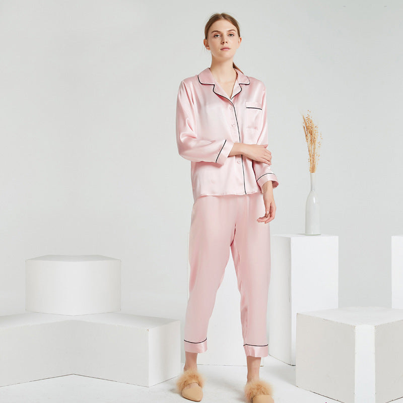Dusty pink silk pajama set folded neatly on a surface