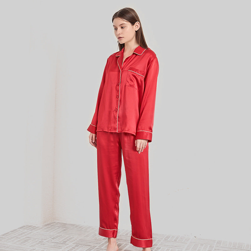 Red silk pajama set with gold trim accent on a model