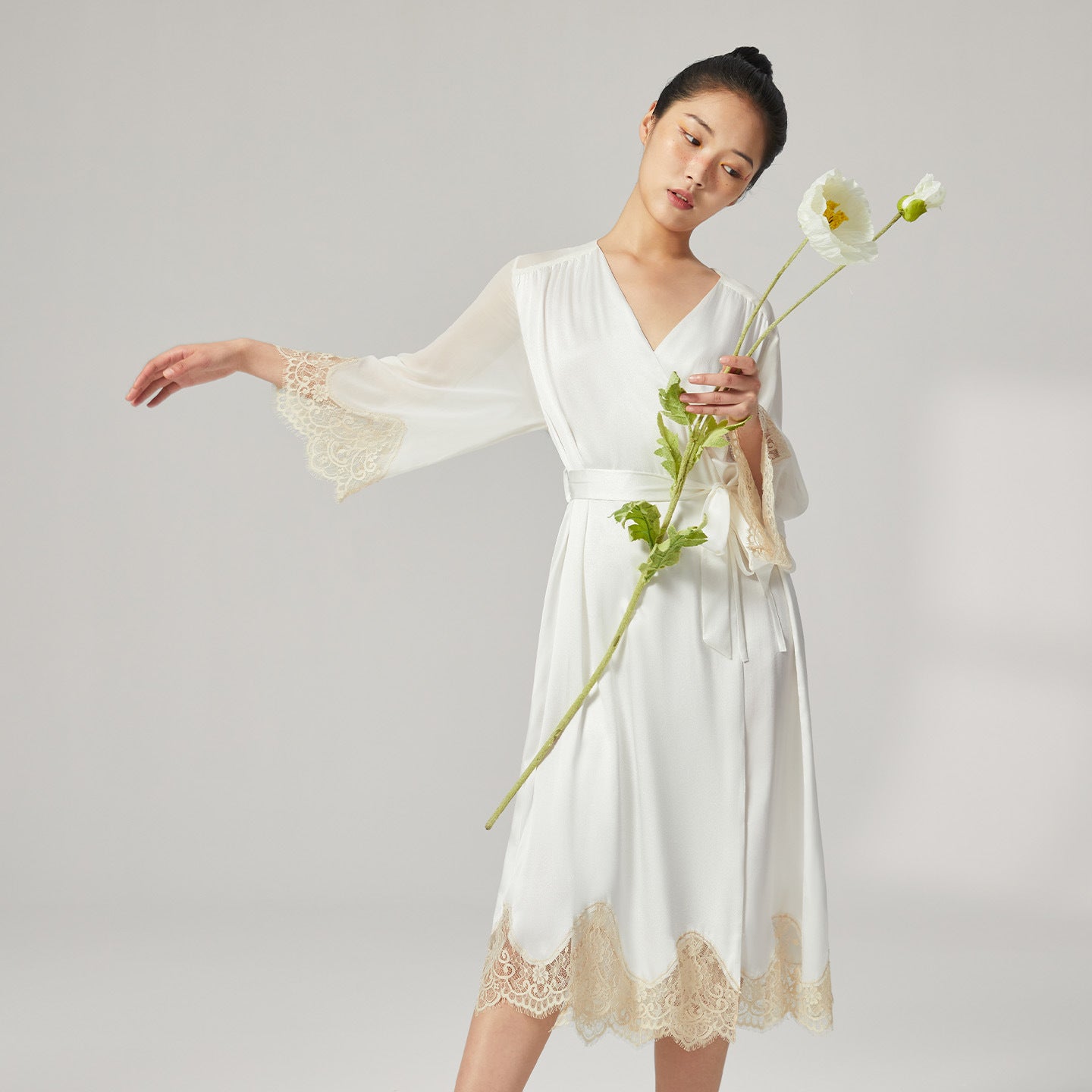 Detail shot of intricate lace trim on robe hem