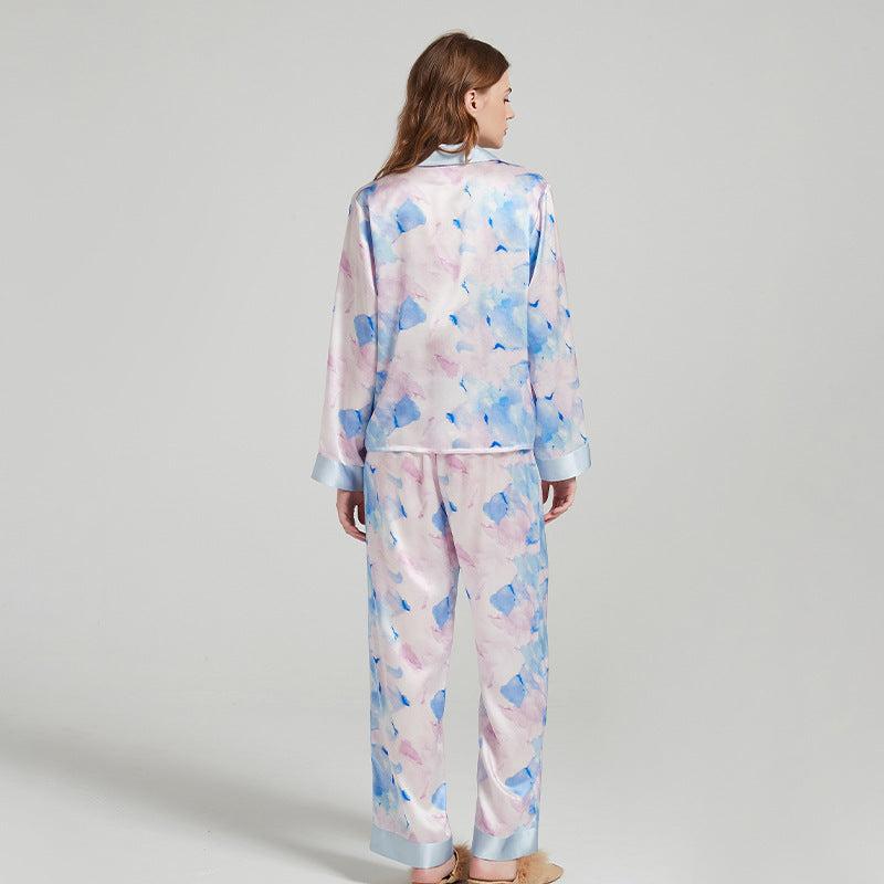Side view of the model lounging in the silk pajama set