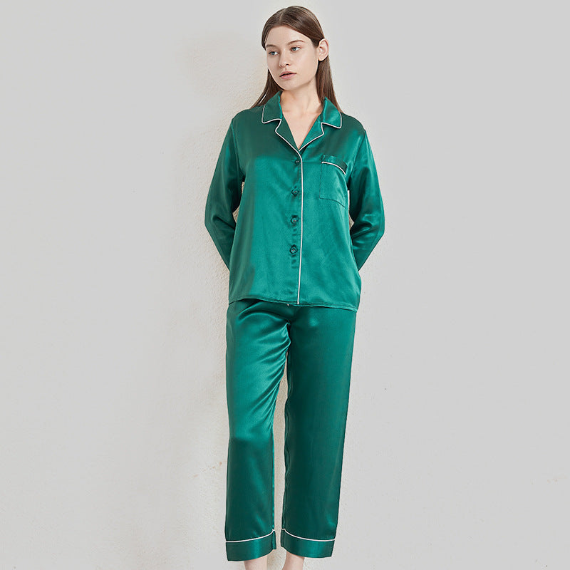 Dark green mulberry silk pajamas displayed flat