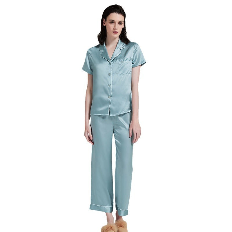 Front detail view of teal blue silk pajama set on plain background