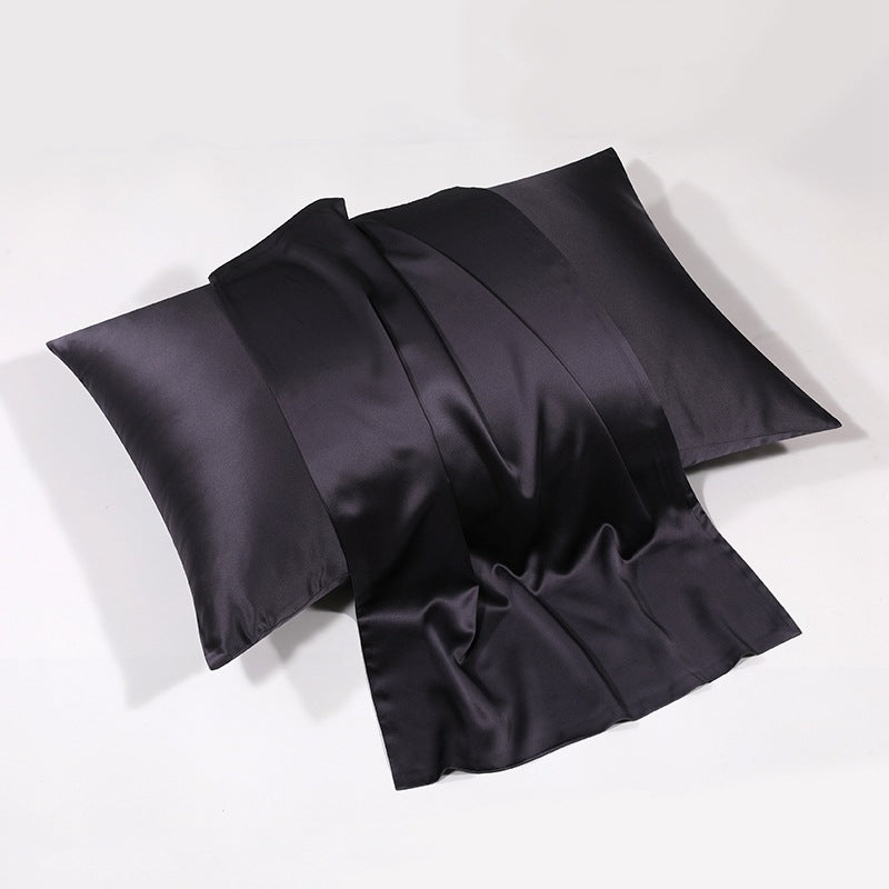 Black silk pillowcase with rich luster on white backdrop