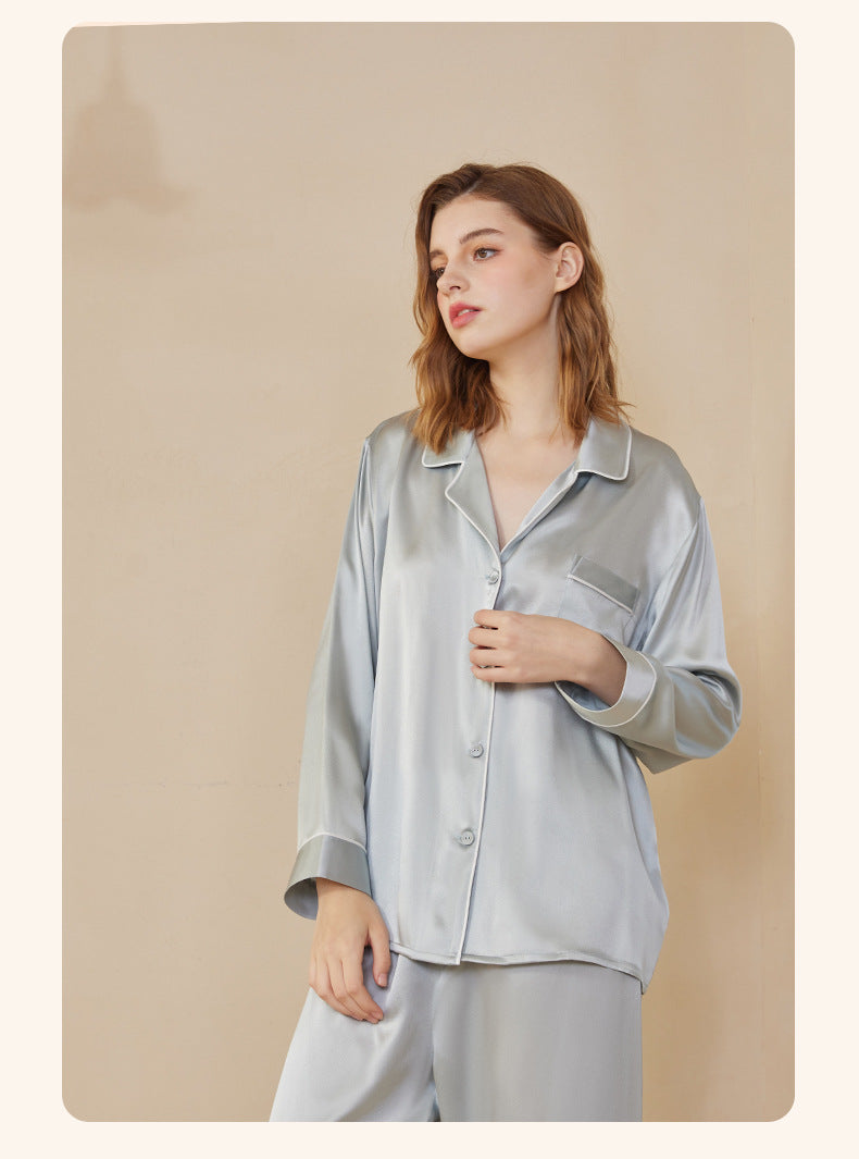 Folded silk pajama set tied with a ribbon in gift-ready packaging
