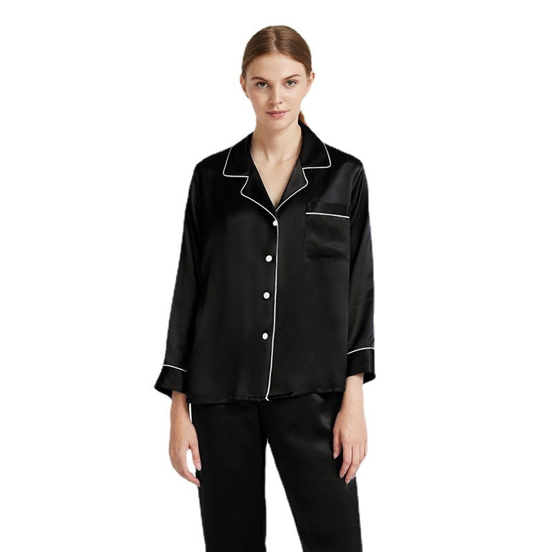 Black silk pajama set with white contrast piping on button-up top