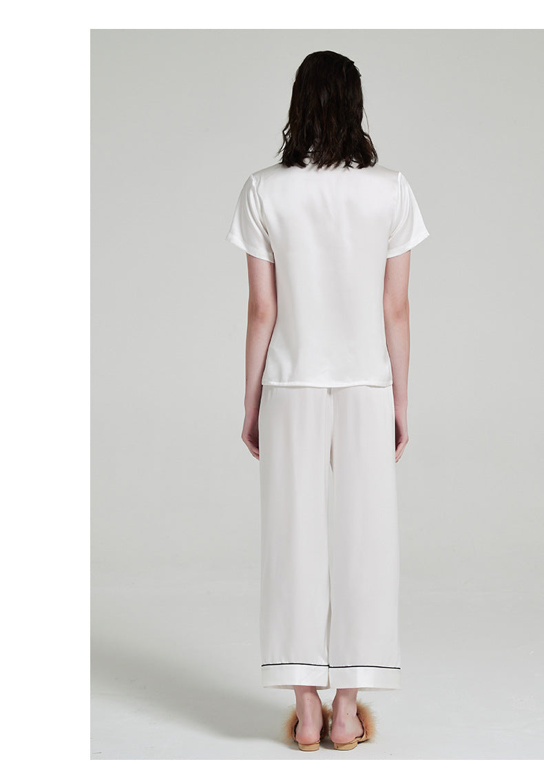 Back view of white silk pajama set showing relaxed fit