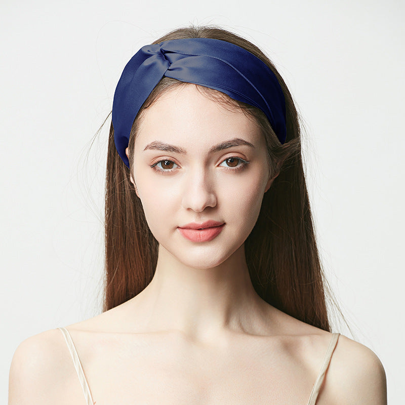 Navy blue silk headband with twisted knot, woman wearing the wide hairband