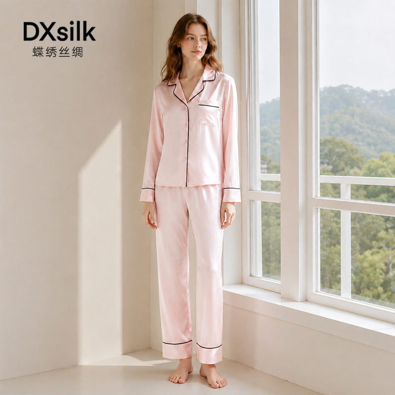 Light pink silk pajama set styled by window with DXsilk branding