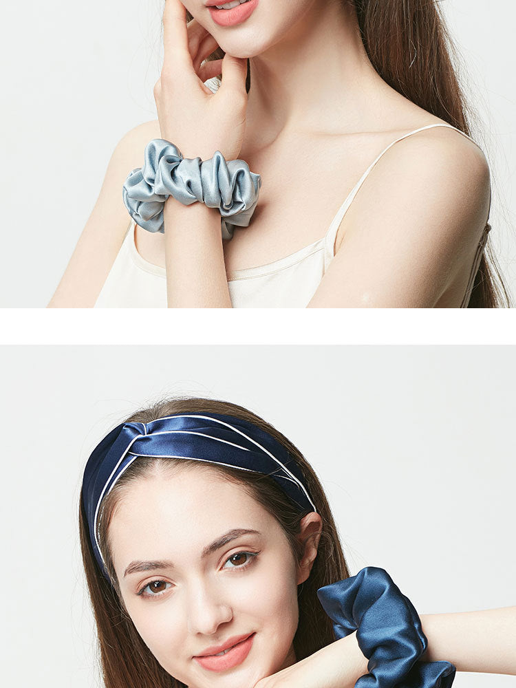 Navy blue silk headband with piped edge and matching navy silk scrunchie on wrist