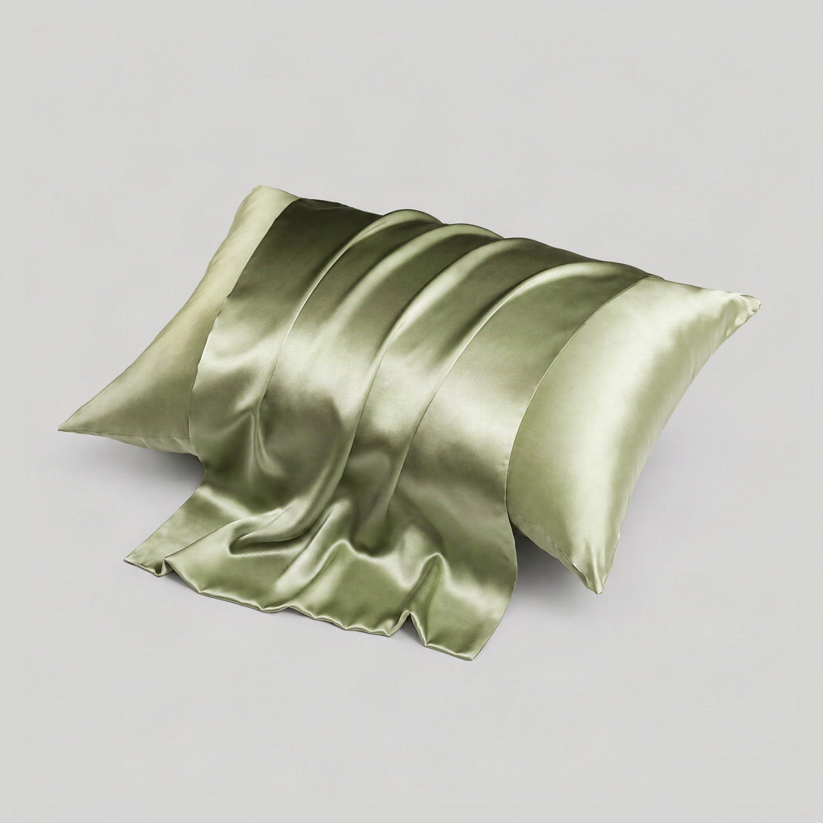 SuuSilk mulberry silk pillowcase draped on a bed, showcasing its smooth sheen and hidden zipper detail in soft natural light.