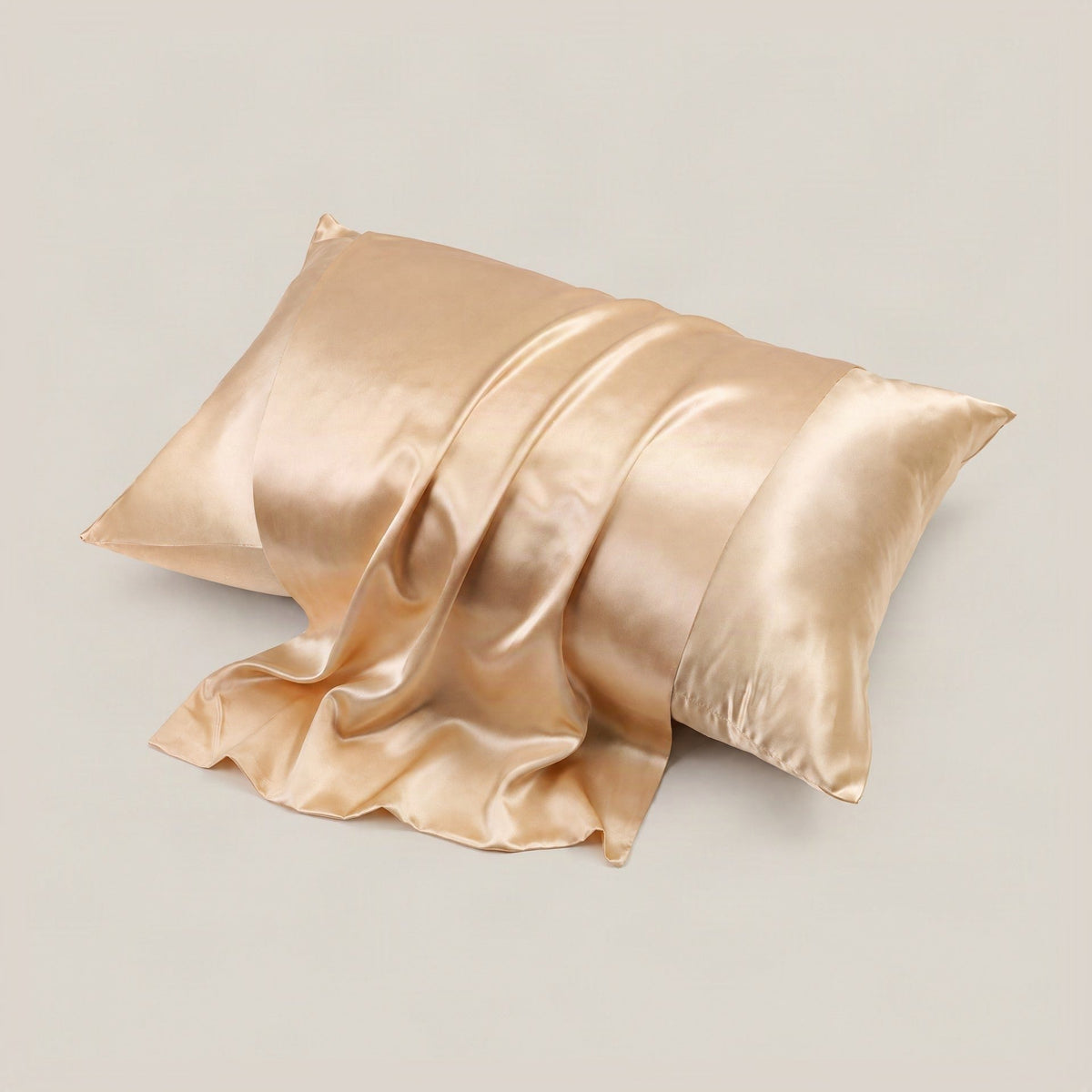 SuuSilk 22 Momme glossy mulberry silk envelope pillowcase in soft pastel tones, displayed on a styled bed setting.