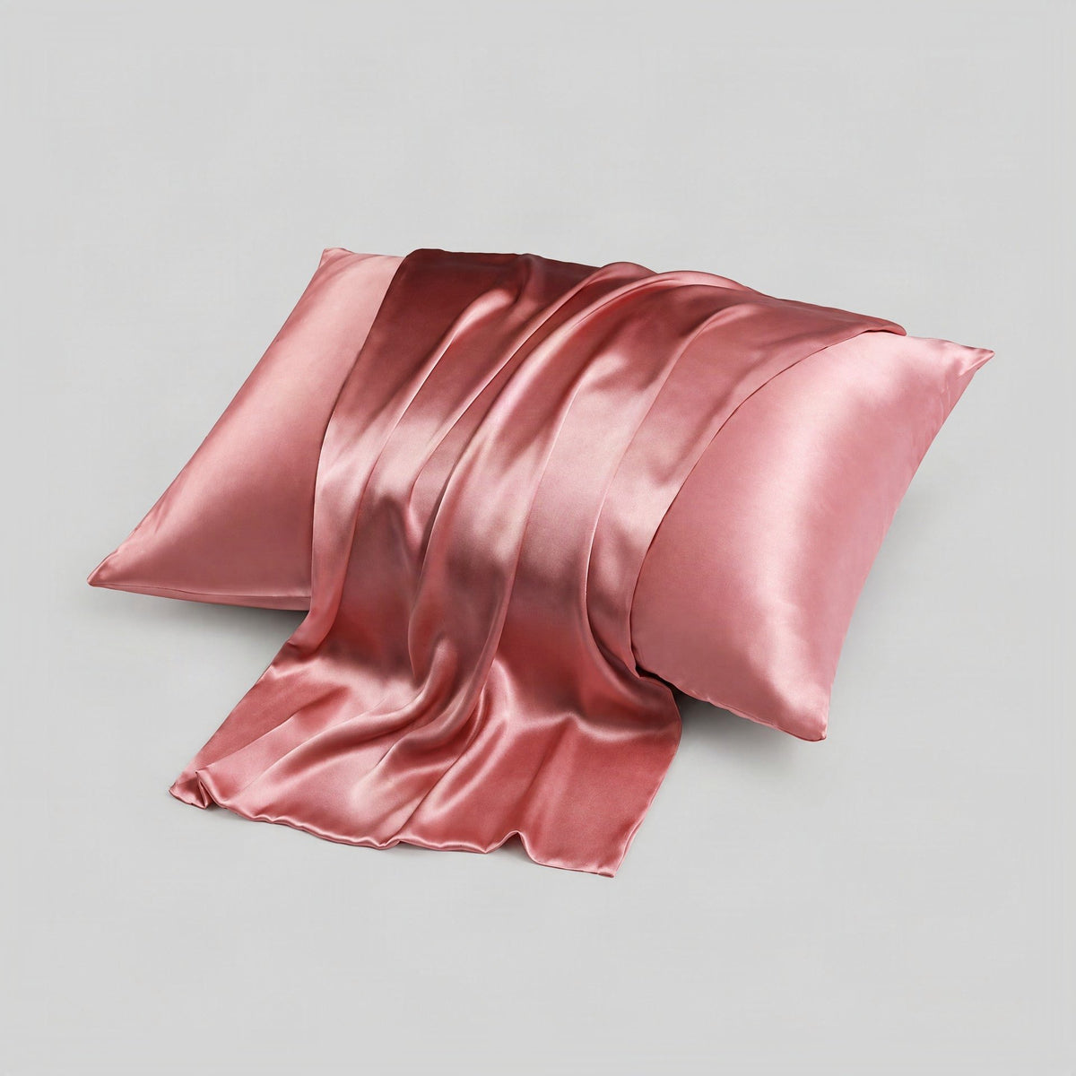 SuuSilk 16 Momme mulberry silk pillowcase in ivory, shown draped on a bed with hidden zipper detail visible