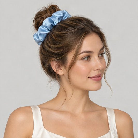 SuuSilk mulberry silk scrunchie in soft pastel hue, gently wrapped around a wrist in natural light